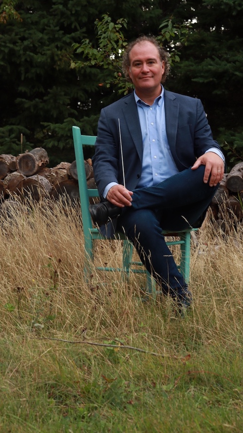 Man sits in chair in meadow