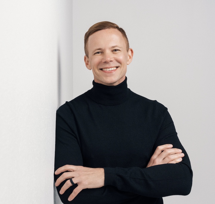 Smiling man standing with arms crossed over chest